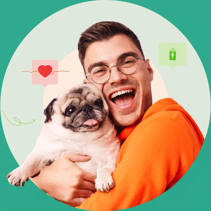 Man happily hugging a pug dog